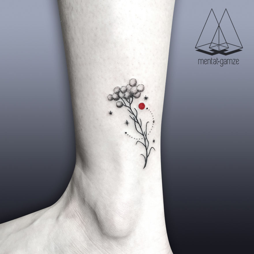 Tattoo art on ankle with floral design and red dot, symbolizing creativity in a tattoo artist's journey.
