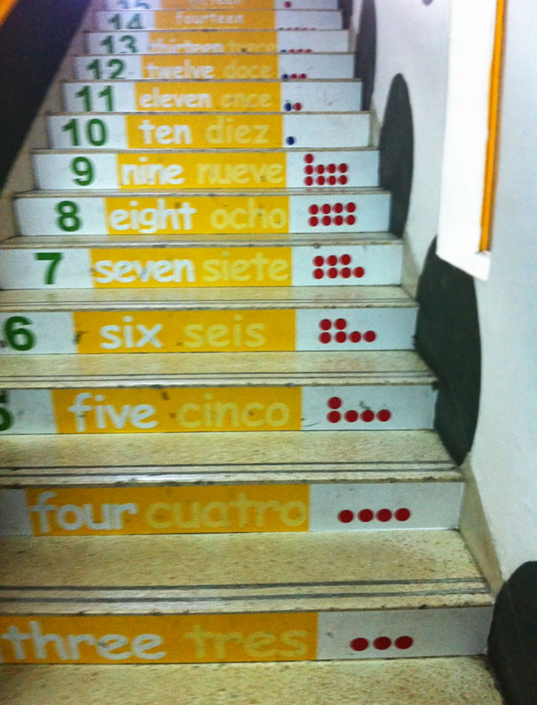 Colorful numbered stairs with numbers in English and Spanish, showcasing a creative school idea.