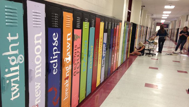 Colorful lockers painted to look like book spines in a school hallway, showcasing creative school ideas.