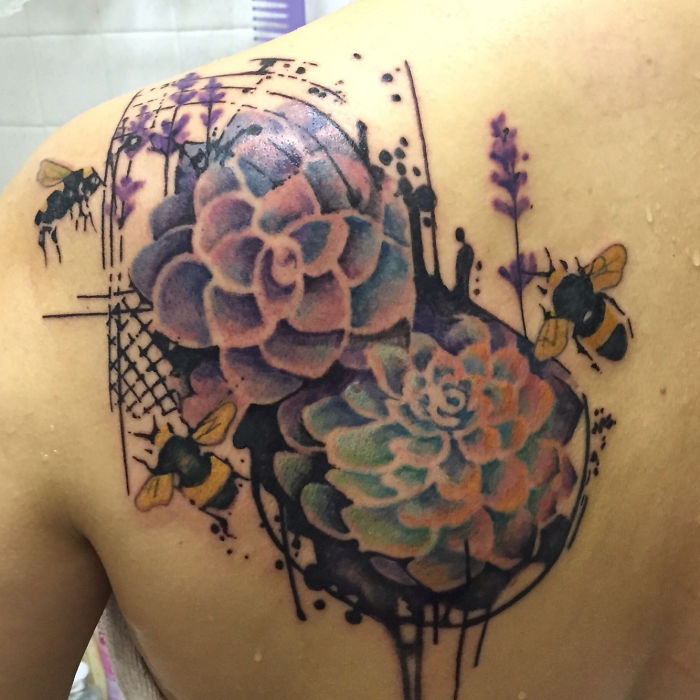 Colorful succulent tattoo on shoulder with bees and abstract elements.