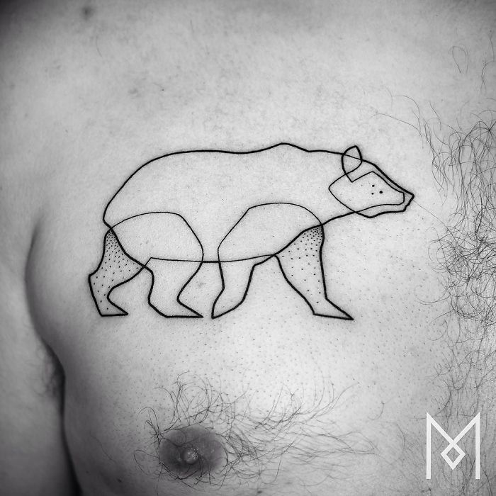 Single continuous line bear tattoo on a man's chest by Mo Ganji.