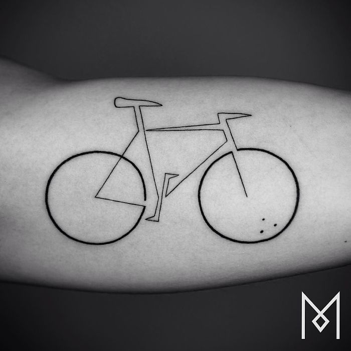 Single line tattoo of a bicycle by Mo Ganji on forearm, showcasing minimalistic tattoo art.