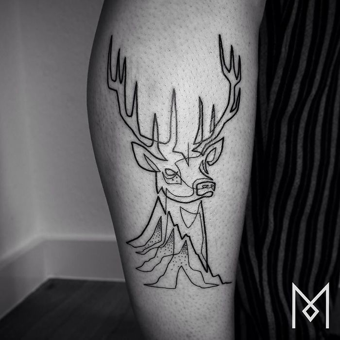 Single continuous line tattoo of a deer on a person's leg, by artist Mo Ganji.
