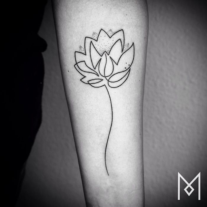 Single line lotus tattoo on forearm by Mo Ganji.