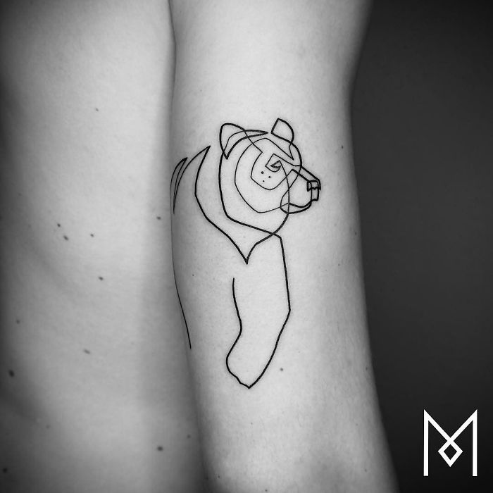 Continuous line tattoo of a bear on an arm by Mo Ganji.