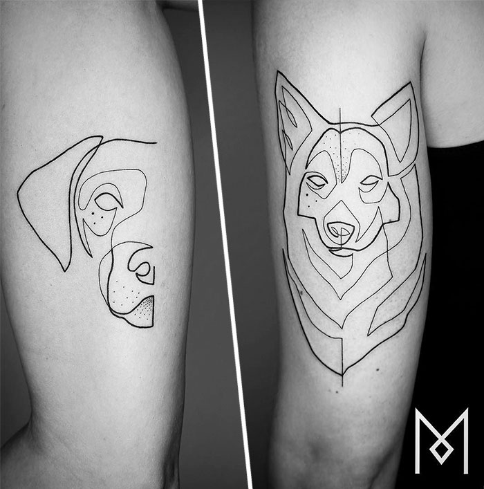 Single continuous line tattoos of a dog and wolf by Mo Ganji on skin.