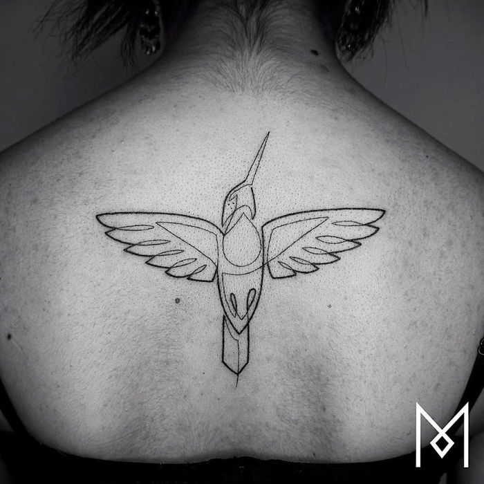 Single line tattoo of a bird on a back, created by Mo Ganji.