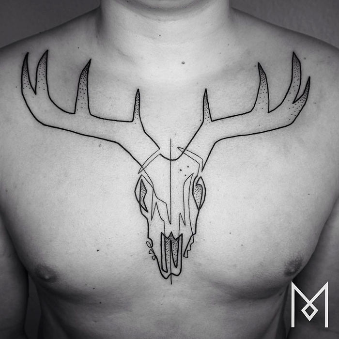 Single line tattoo of deer skull on chest by artist Mo Ganji.