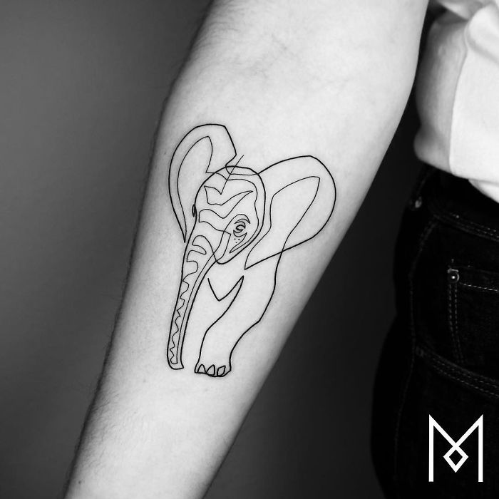Single line elephant tattoo on forearm by artist Mo Ganji.