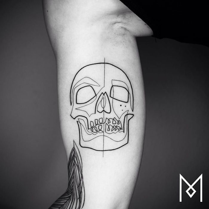 Single line skull tattoo by Mo Ganji on forearm, minimalist design in black ink.
