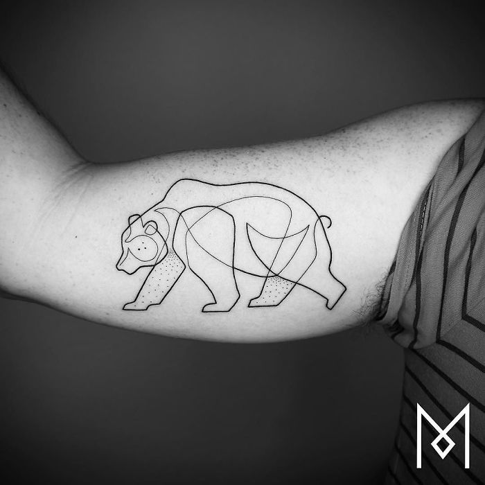Single continuous line bear tattoo by Mo Ganji on a person's arm, showcasing minimalist tattoo art.