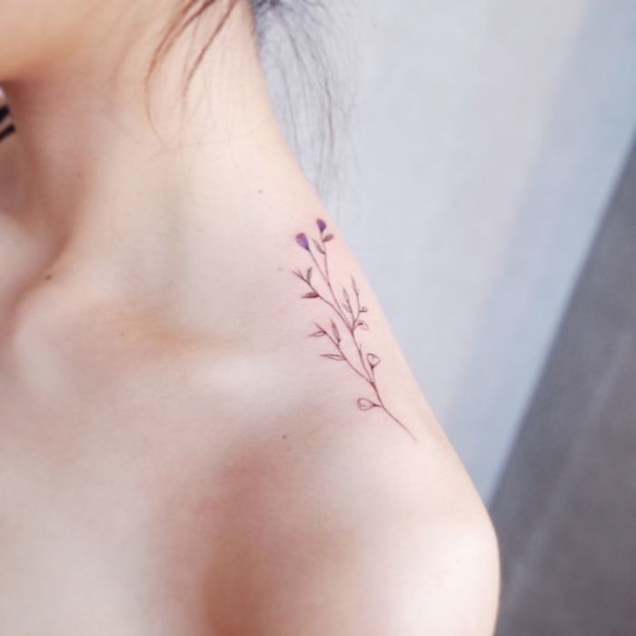 Minimalism tattoo of a delicate floral design on the shoulder, showcasing discreet body art.