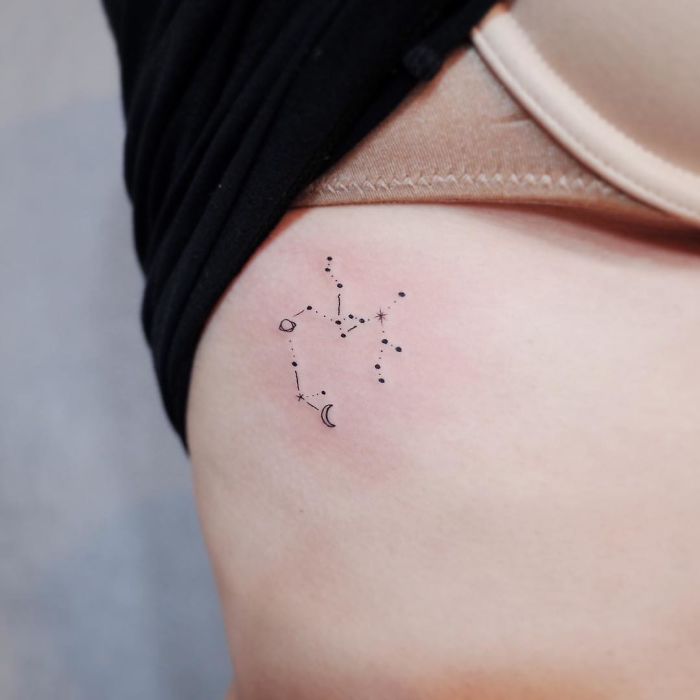 Minimalist tattoo of a constellation on a person's side.