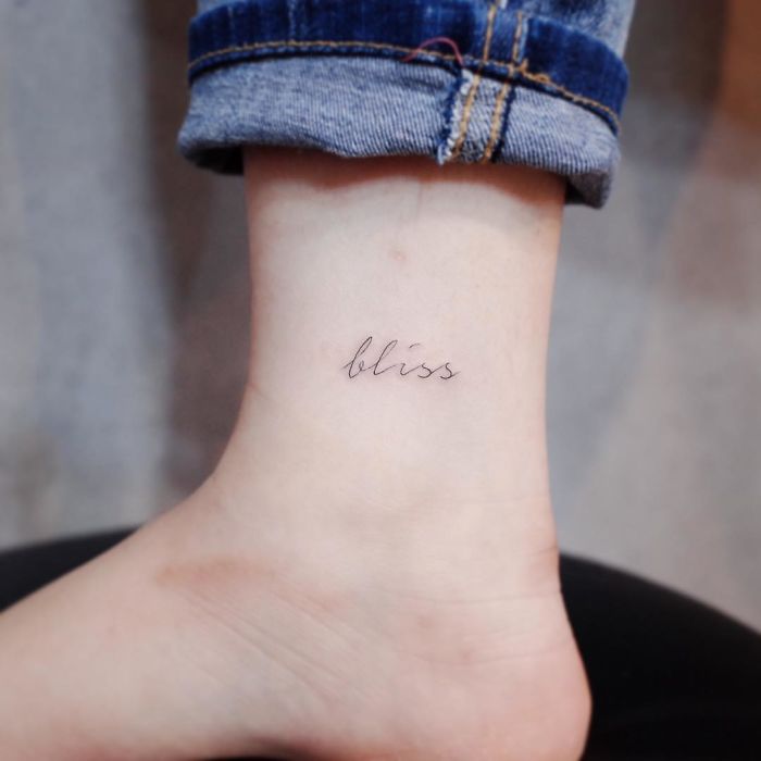 Minimalist tattoo with the word "bliss" on the ankle.