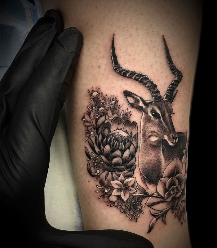 Succulent tattoo featuring a detailed antelope with floral designs, perfect for succulent enthusiasts.