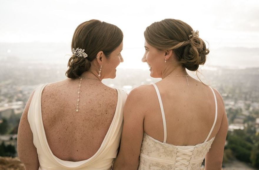 Two women looking at each other and sitting 
