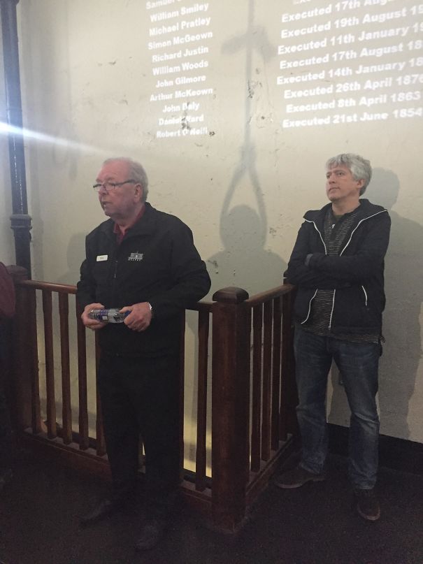 Tour Guides Shadow Reflecting A Man Being Hung At The Gallows.