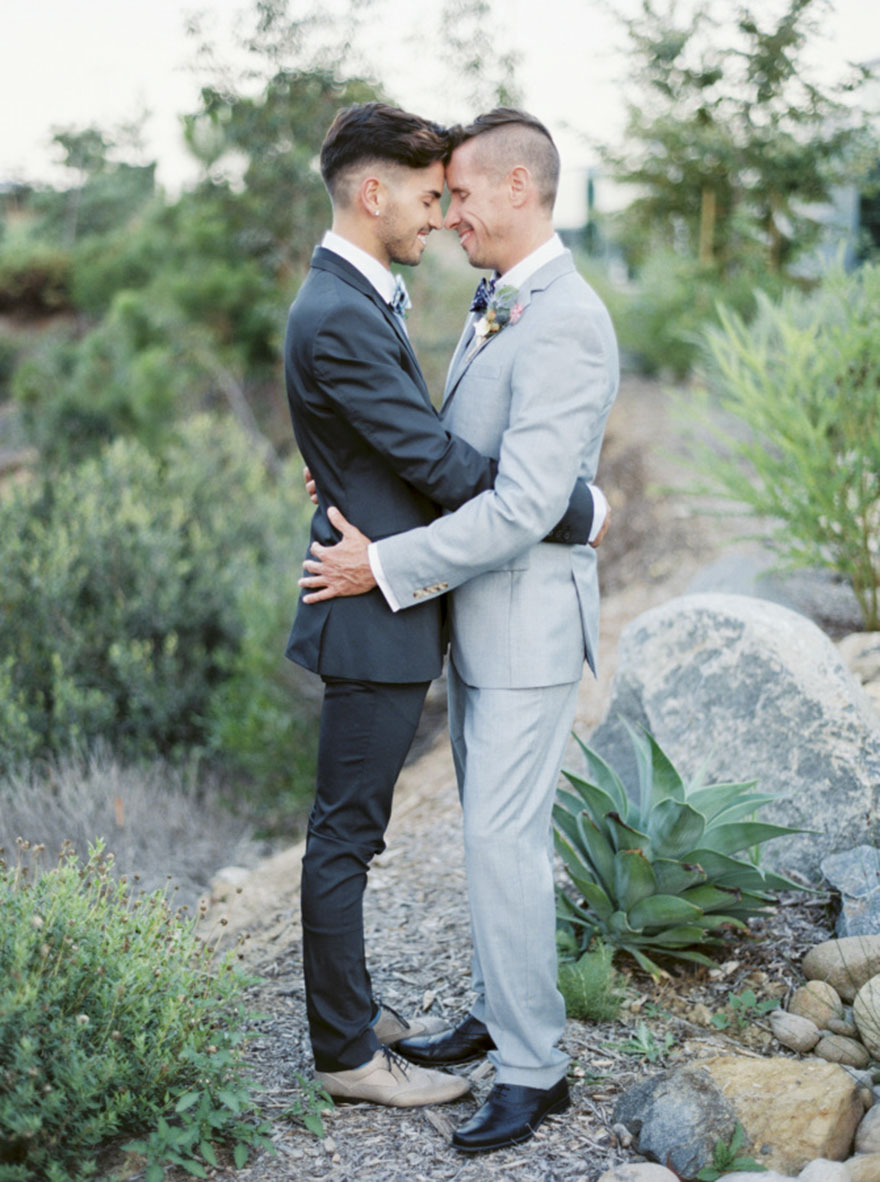 Two men hugging and looking each other in the eyes 