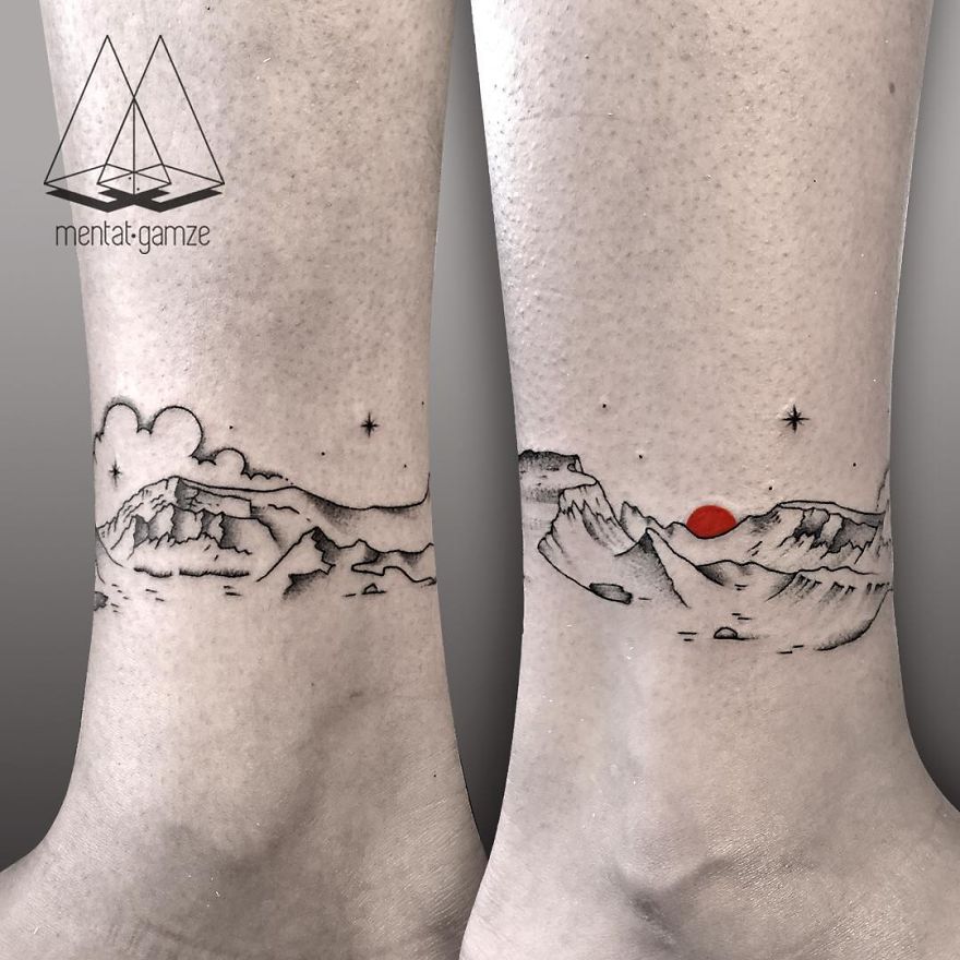 Minimalist mountain landscape tattoo with a red dot, showcasing a creative design by a tattoo artist.