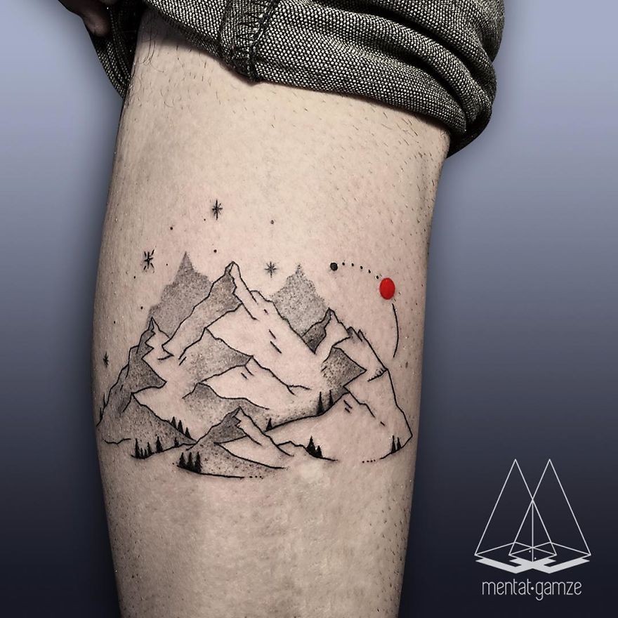 Tattoo of mountains and a red dot on skin, symbolizing a career change to tattoo artist.