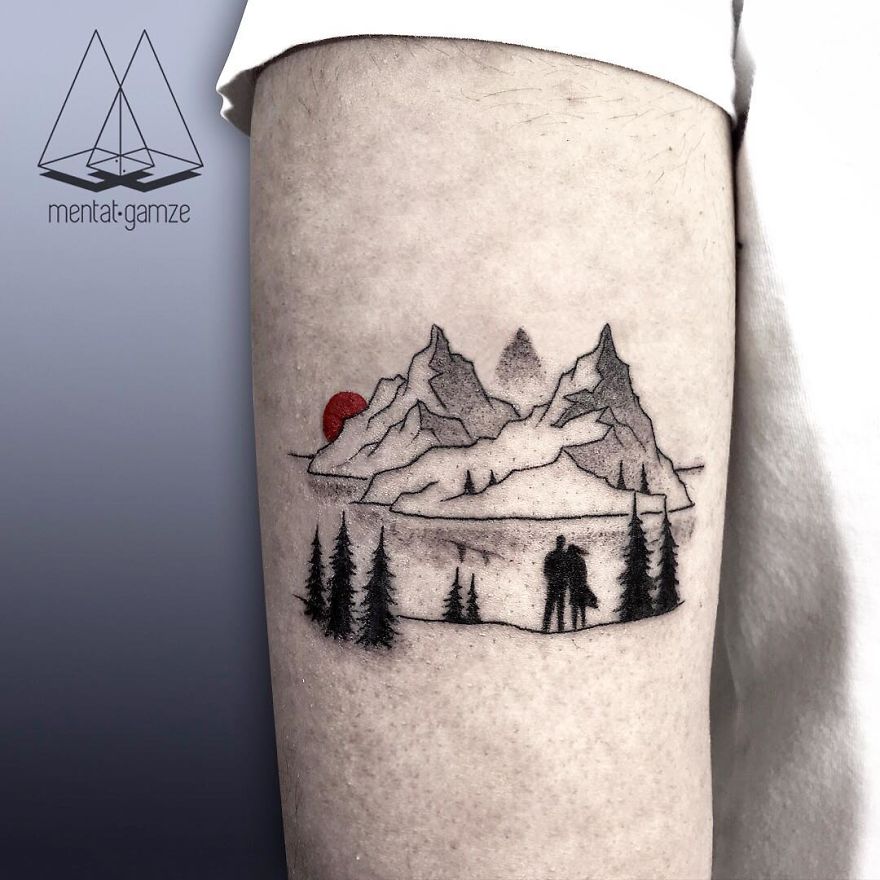Tattoo of mountains and trees with a red dot, illustrating a journey from a boring job to becoming a tattoo artist.