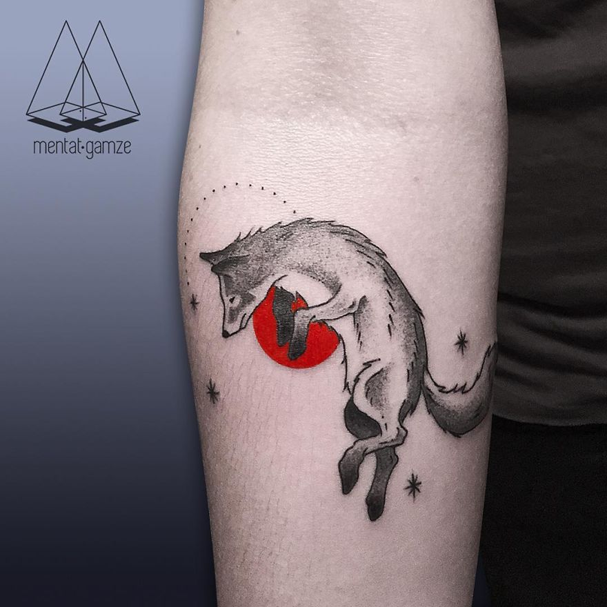 Wolf tattoo design featuring a red dot, symbolizing a bold tattoo artist's journey from a mundane job to creative freedom.