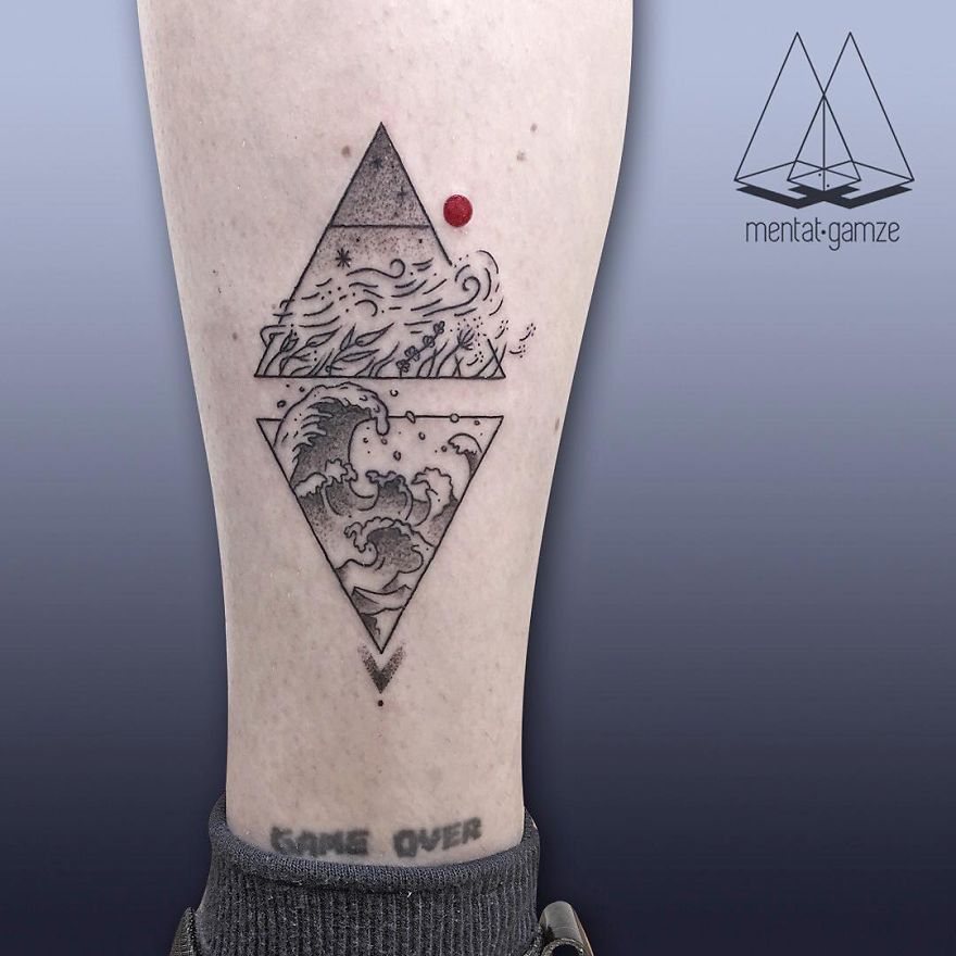 Tattoo artist's leg tattoo featuring geometric design with a red dot, waves, and abstract elements.