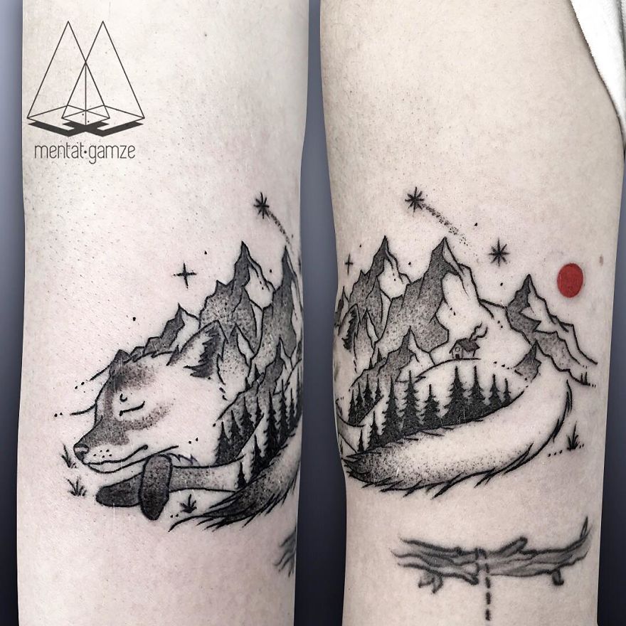 Tattoo of a fox and mountain landscape with trees and a red dot, showcasing artistic transition from a boring job.