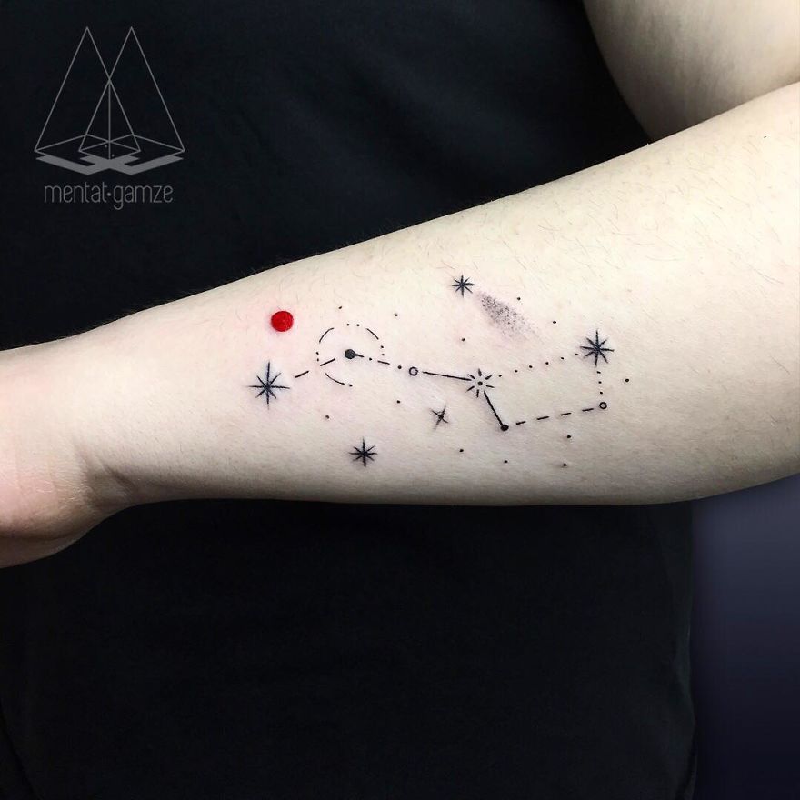 Tattoo artist's work of stars and a red dot on an arm, symbolizing a creative career change.