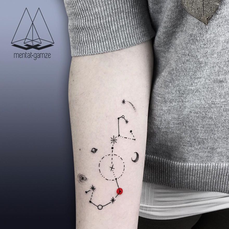 Tattoo of constellations and a red dot on an arm, showcasing a transition to a tattoo artist career.