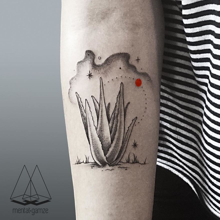 Aloe plant tattoo with a red dot on an arm, showcasing unique tattoo artistry.