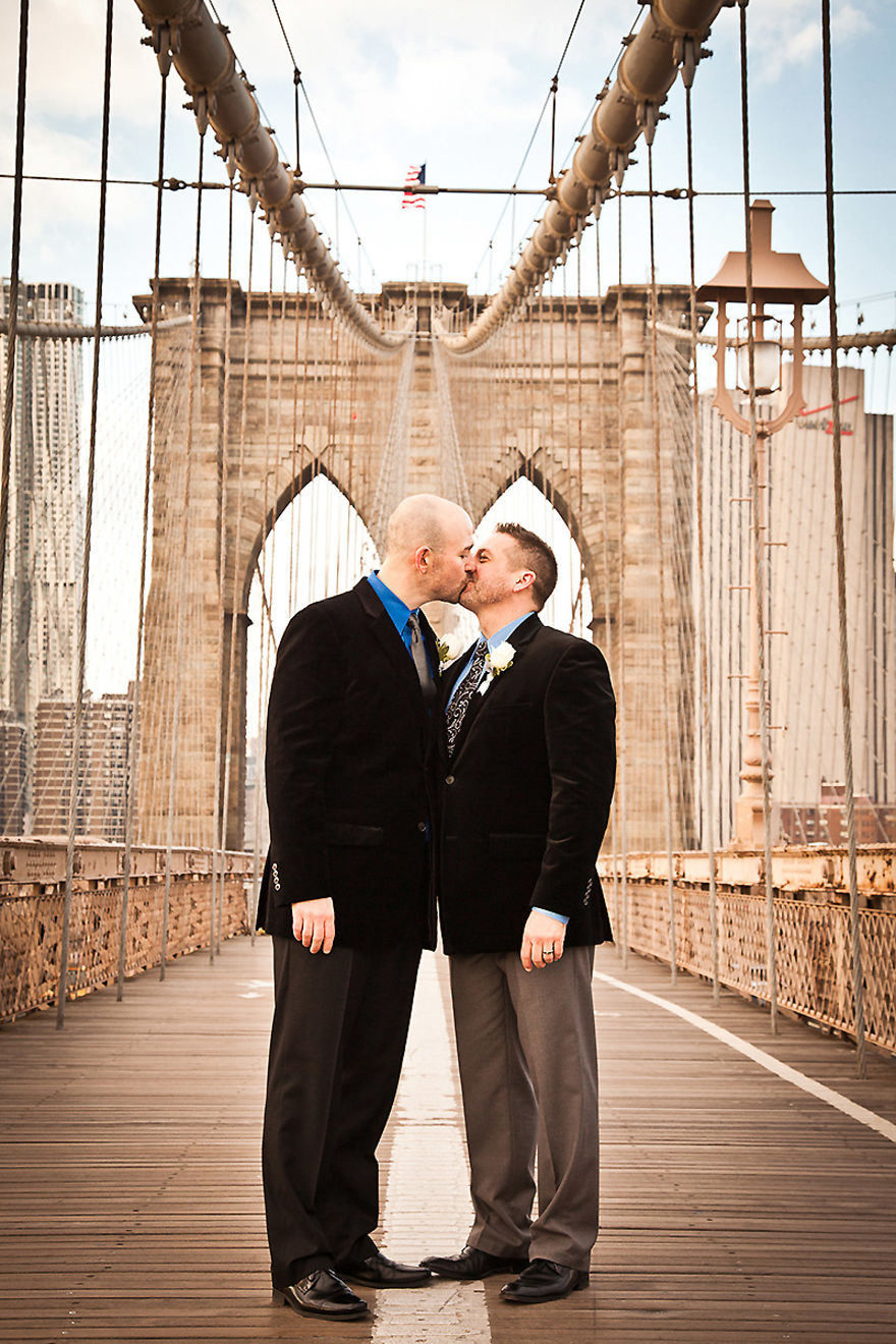 Two men kissing on the bridge 