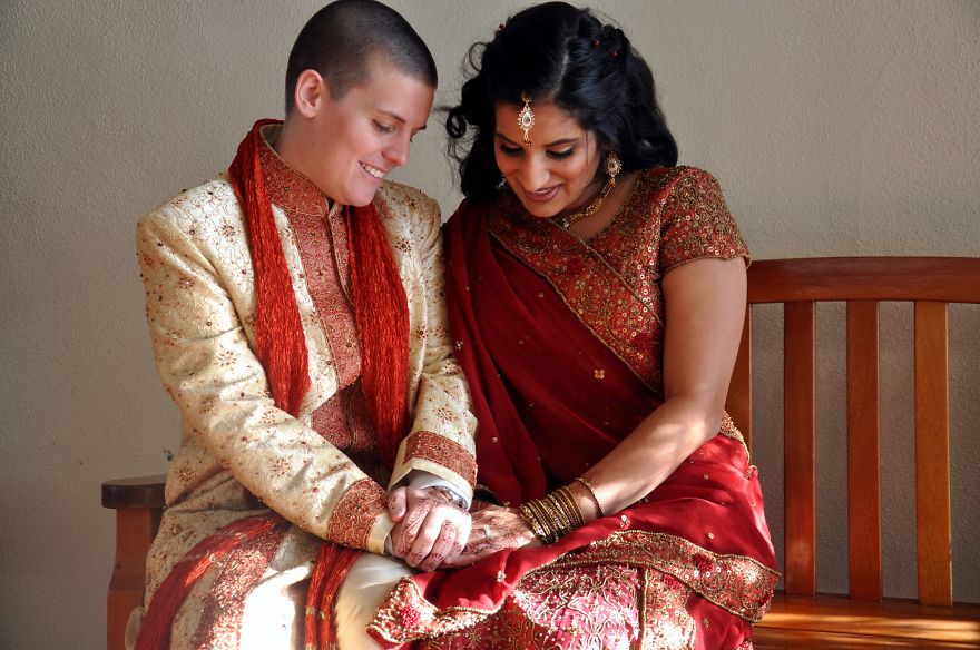 Two happy woman holding hands and sitting 