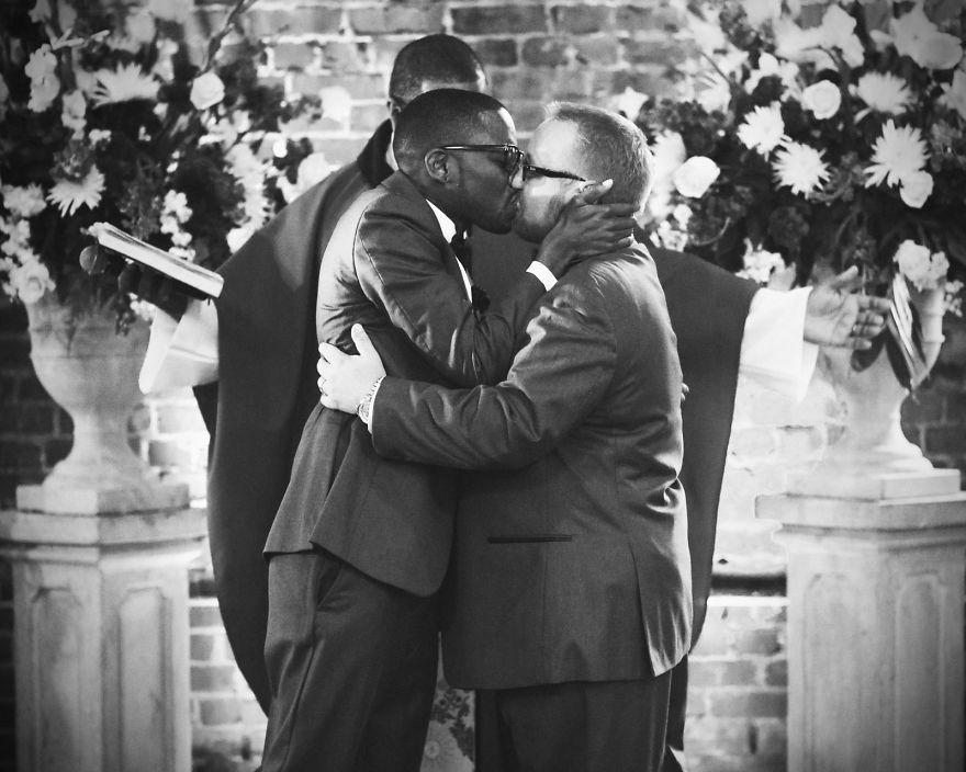 Two men kissing each other 