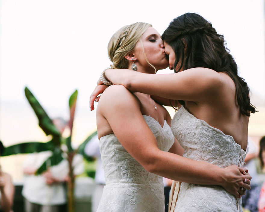 One woman kissing other woman on forehead