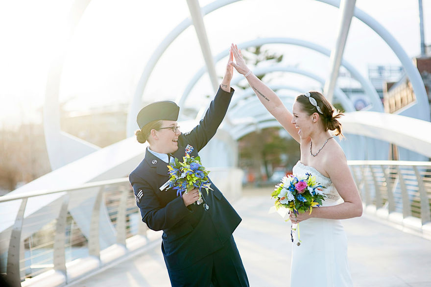 Two women high fiving each other 