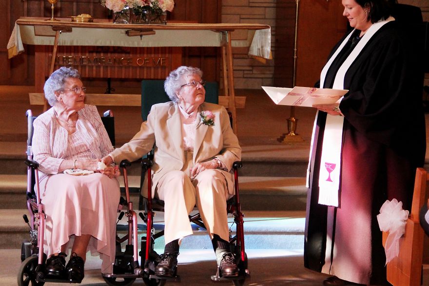 Two grandmas in wheelchairs in a church 