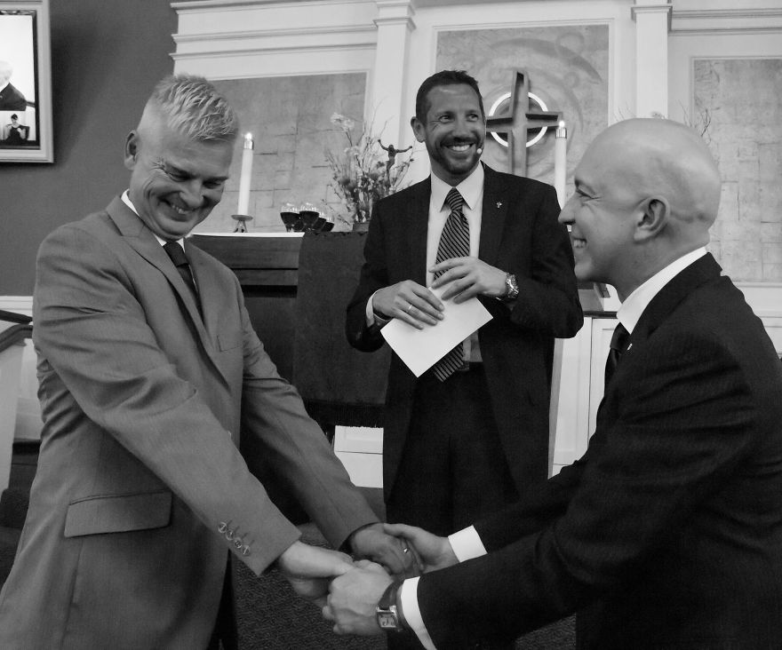 Two happy men holding each others hands 