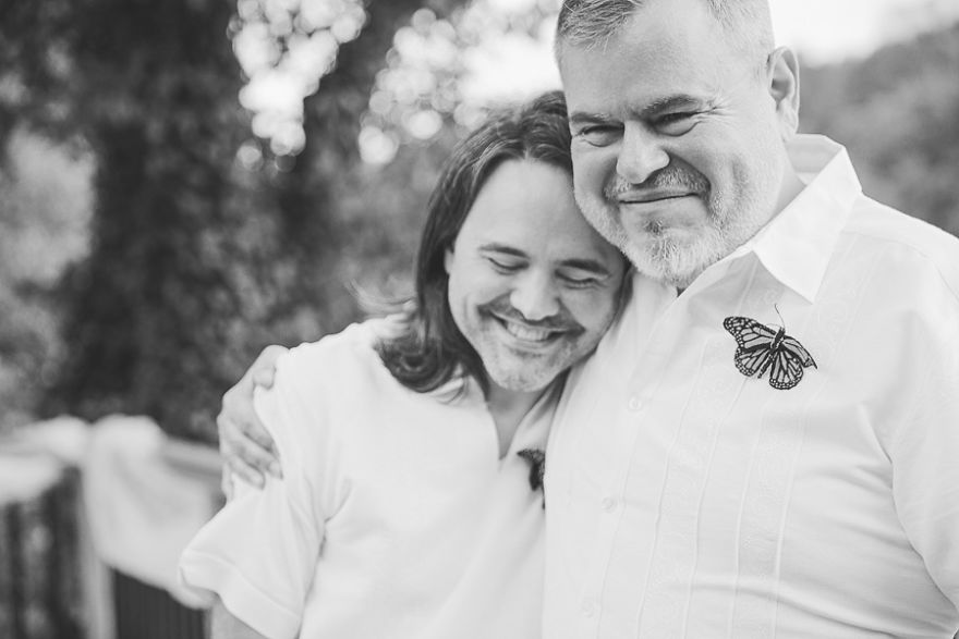 Two men hugging and smiling 