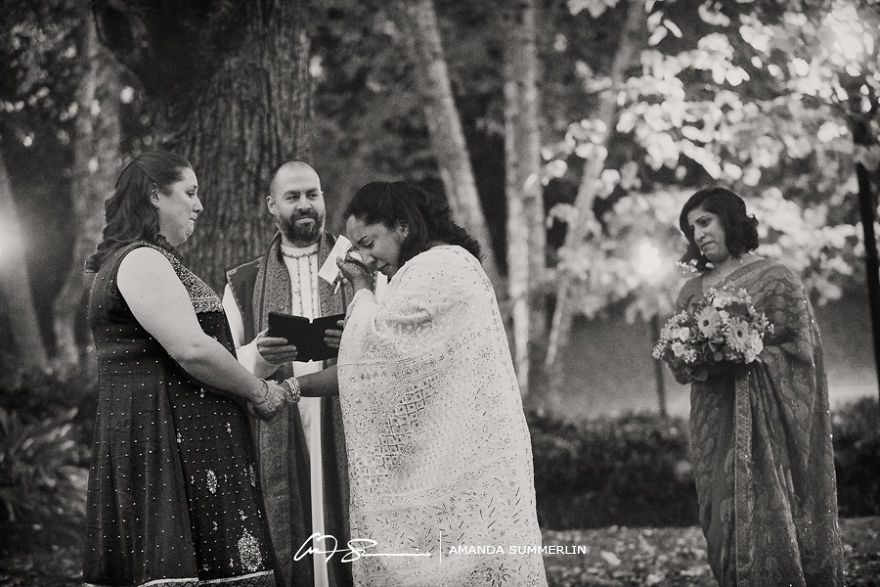 Two woman crying standing near a pastor 