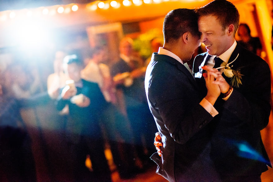 Two men dancing and smiling on stage 