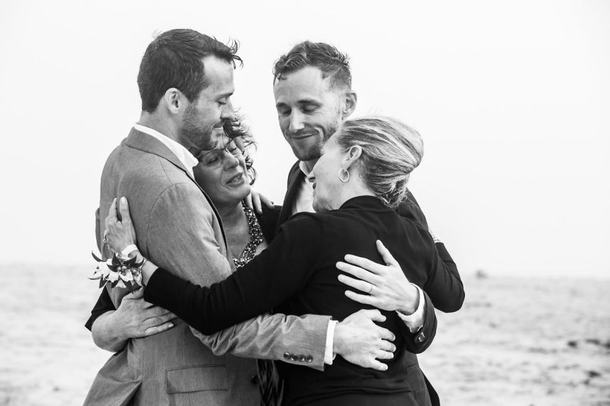 Two men and two woman hugging 