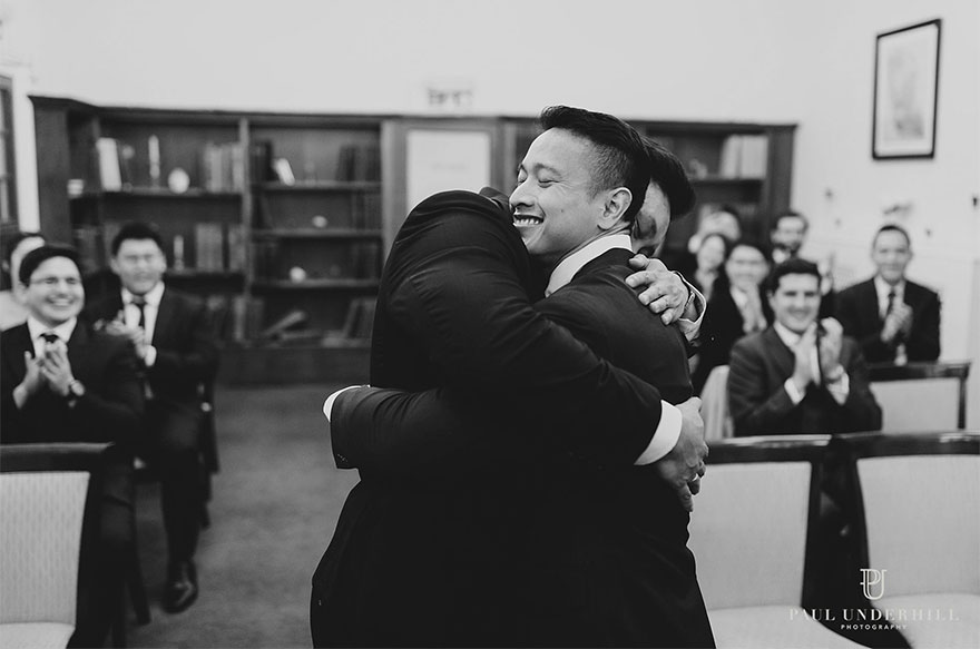 Two men hugging and smiling 