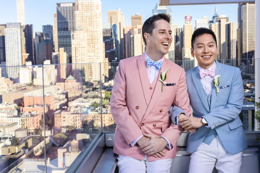 Two men posing on building's roof 