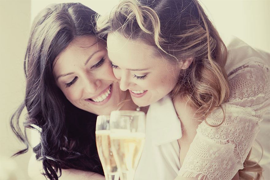 Two women smiling and drinking champagne 