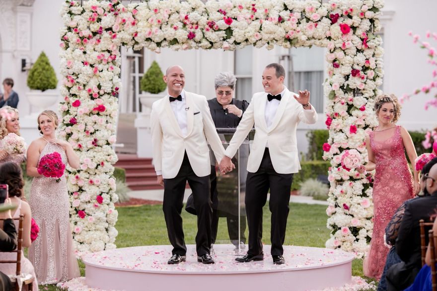 Two men holding hands on stage 