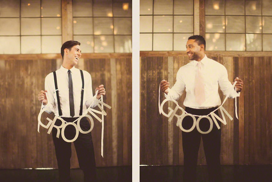 Two men holding decorations while looking at each other 