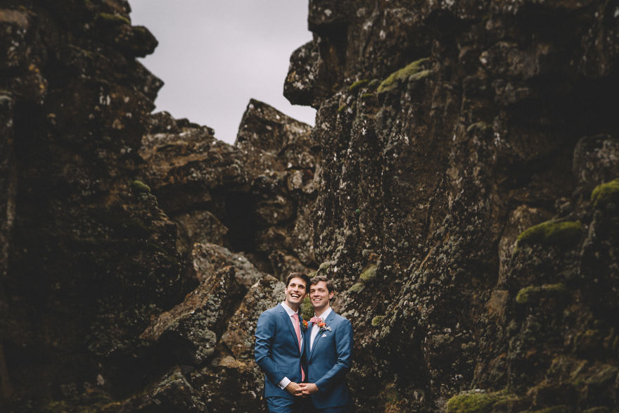 Two man holding hands surrounded by mountains 