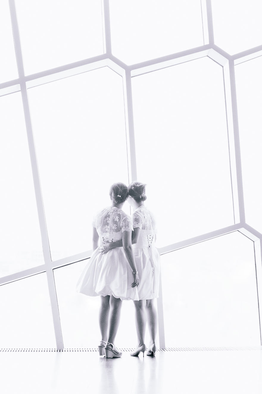 Two woman hugging and looking through the window 