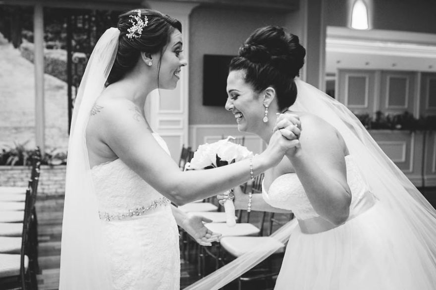 Two happy women holding hands and laughing 